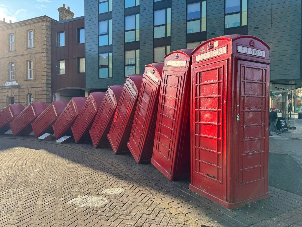 Image of the 'Out of Order' artwork in Kingston, London showing red telephone boxes.